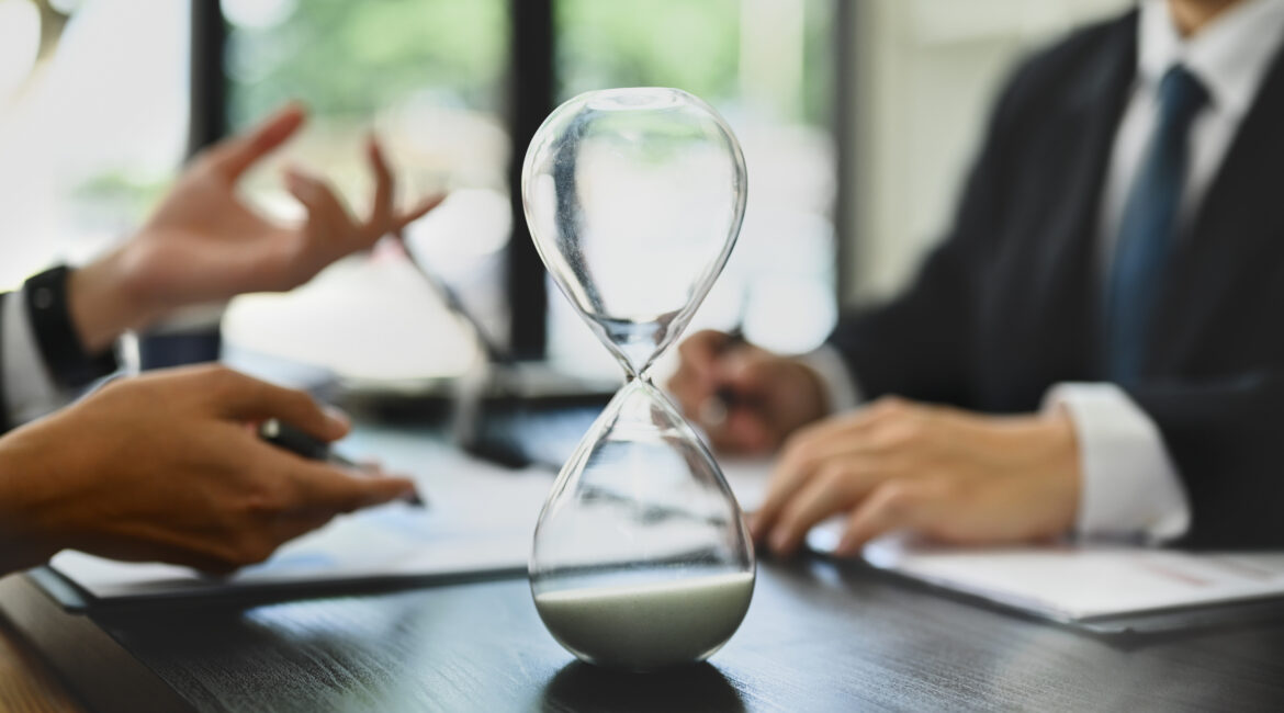 Hourglass on desk during realtor interview meeting